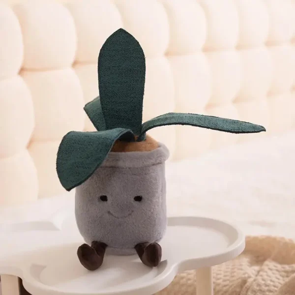 Peluche Aloe Vera kawaï, pot gris souriant avec pattes, feuilles vertes texturées. JELLYCAT