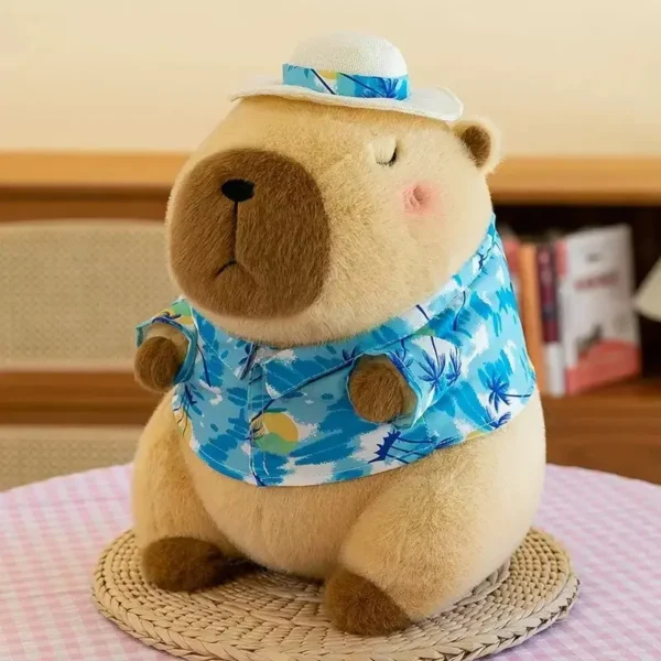 Peluche Capybara kawaii, chemise hawaïenne bleue et chapeau de paille, expression paisible.
