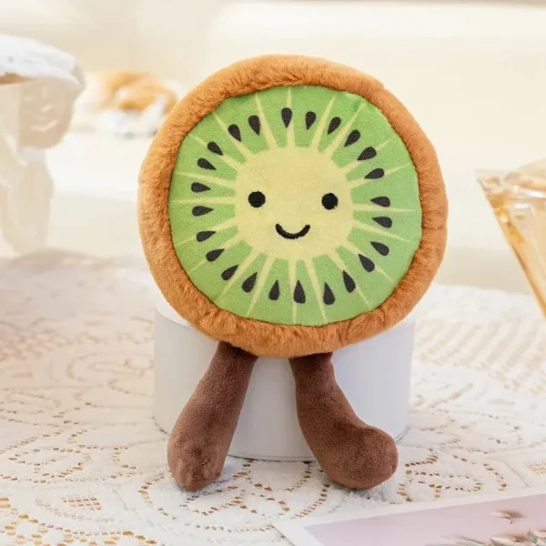 Peluche Kiwi design Jelly, tranche de fruit verte avec visage mignon et jambes pendouillantes.