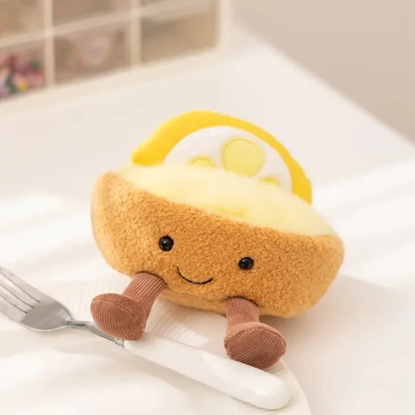 Peluche tarte au citron souriante, façon Jellycat, croûte duveteuse, jambes velours.